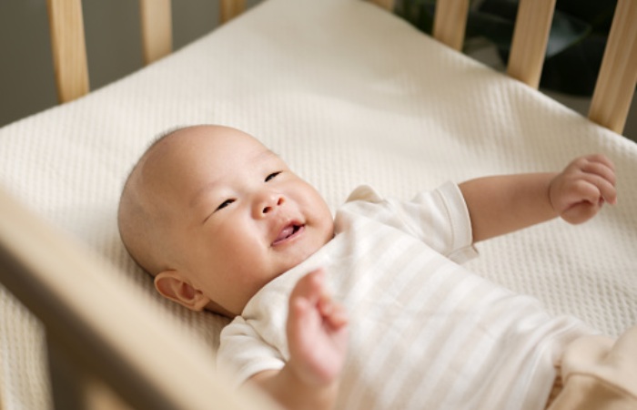 How much time can a baby spend sleeping in a small crib?